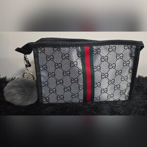 Gray Inspo Pouch with a monogram  and a green and red ribbon with Pom Pom